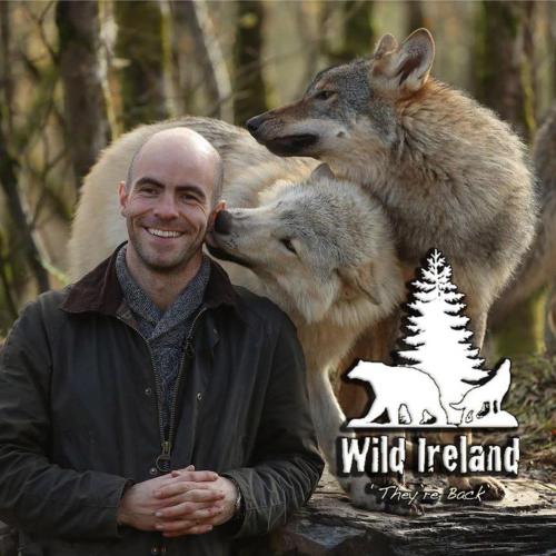 a man is posing for a picture with two wolves at Lily’s Town House in Buncrana