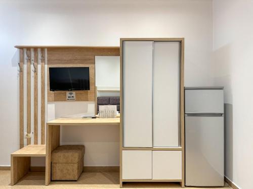 a room with a desk and a refrigerator at Hotel Meta Ksamil in Ksamil
