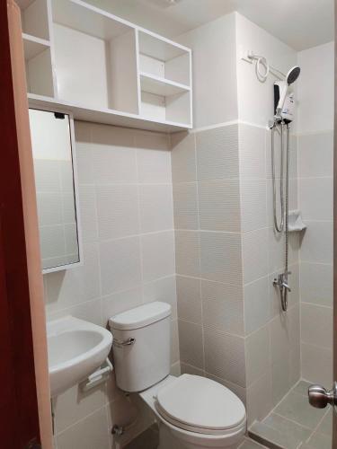 a bathroom with a toilet and a sink at Studio Type BNB Accommodation in Bacolod