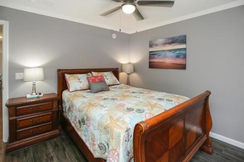a bedroom with a bed and a ceiling fan at Salty Breeze by Pristine Property Vacation Rentals in Saint Joe Beach