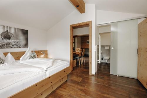 a bedroom with a large bed with a wooden frame at Hubertus - Das Landhaus in Kleinarl