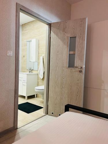a bedroom with a door open to a bathroom at Apartament Na Starówce in Kłodzko