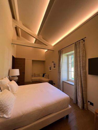 a bedroom with a large bed and a window at Domaine de Panery in Pouzilhac