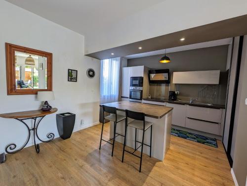 - une cuisine avec un îlot au milieu d'une pièce dans l'établissement Maison spacieuse avec jardin proche plage & centre, à Pornic