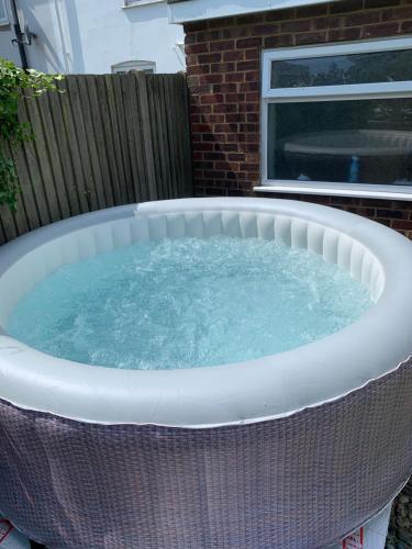 a large jacuzzi tub in a backyard at Walmer House in Deal