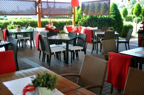 a restaurant with tables and chairs with red napkins at Ahotel in Czechowice-Dziedzice