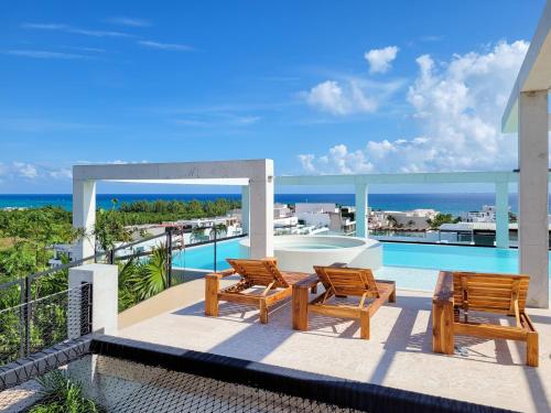 a view of the ocean from the balcony of a house at Ceren Luxury Apartments at Fifth Avenue by Spot Rentals in Playa del Carmen
