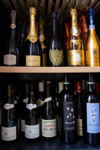 a bunch of bottles of wine on a shelf at LA VILLA in Terraube