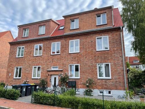 a large red brick building with white windows at Villa Backstein OBO19 in Schwerin