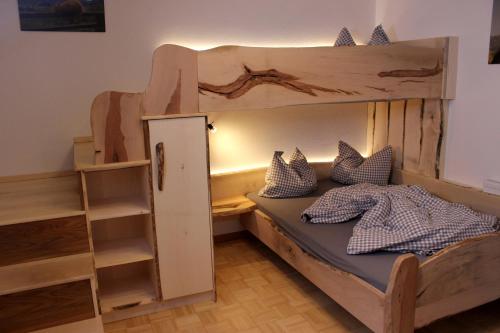 a bedroom with a bunk bed with a ladder at Familienbauernhof Christa in Rossleithen