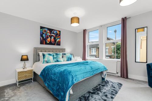 a bedroom with a bed and a window at Elegant Hither Green Family Home in London