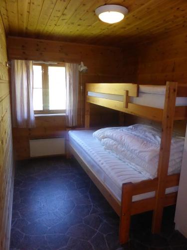 a bedroom with two bunk beds in a cabin at Skei Servicenter in Skei