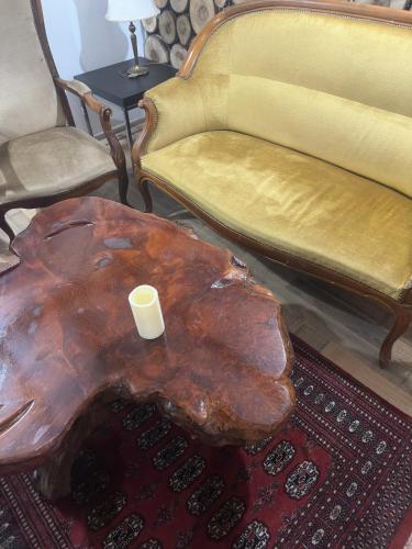 a living room with a wooden stump table and chairs at Paradise on the Vrbas River in Jajce
