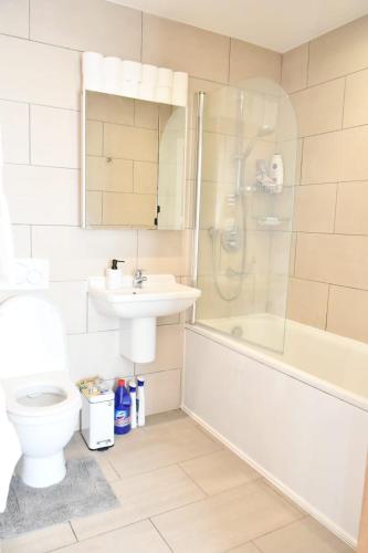 a bathroom with a toilet and a sink and a shower at Spacious 2bedroom apartment in London city airport in London