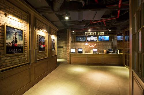 a theater room with a ticket booth and signs on the wall at Liberty Central Saigon Citypoint in Ho Chi Minh City