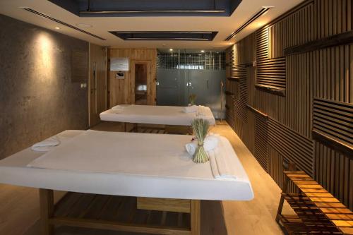a room with two beds and a table in it at Liberty Central Saigon Citypoint in Ho Chi Minh City