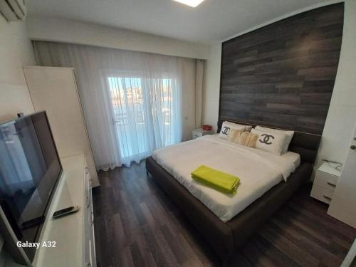 a bedroom with a bed and a flat screen tv at 3 Bedrooms villa Fanadir in Hurghada