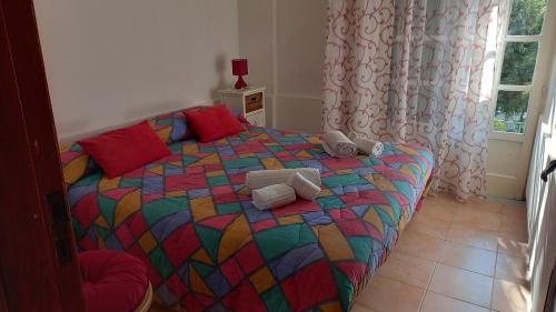 a bedroom with a colorful bed with towels on it at Casa vacanze Alfano in Ascea