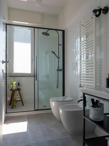 a bathroom with a shower and a tub and a sink at Appartamento Orti in Arese