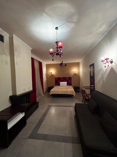 a large room with a bed and a couch at Faraggi Hotel in Simvolí