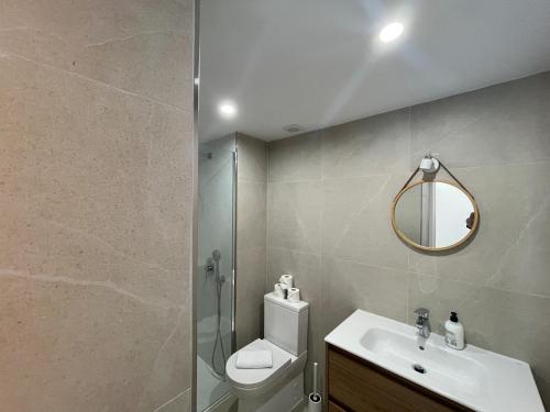 a bathroom with a toilet and a sink and a mirror at Casa Sasera in Colonia Sant Jordi