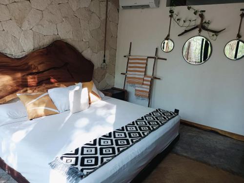 a bedroom with a bed and some pendant lights at Agua & Selva luxury Jungle loft in Tulum