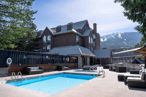 a hotel with a swimming pool in front of a building at Adara Hotel in Whistler