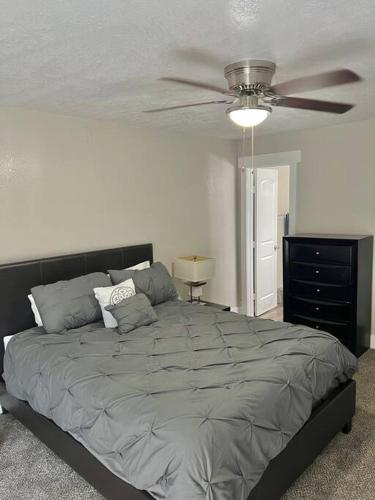 a bedroom with a large bed with a ceiling fan at Lovely 2-bedroom condo next to AT&T Stadium in Arlington