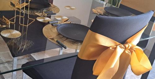 a table with a chair with a yellow bow at The Palm Villa in St Paul's Bay