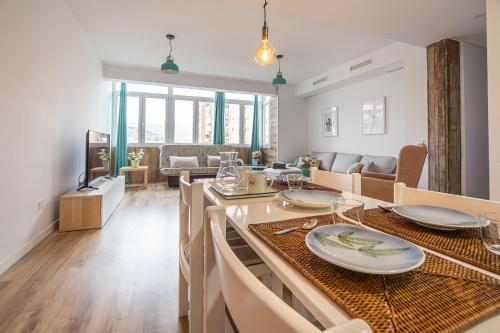 - une salle à manger et un salon avec une table et des chaises dans l'établissement CARTAGENAFLATS, Piso Moderno 3 Dormitorios, Cartagena Center, à Carthagène