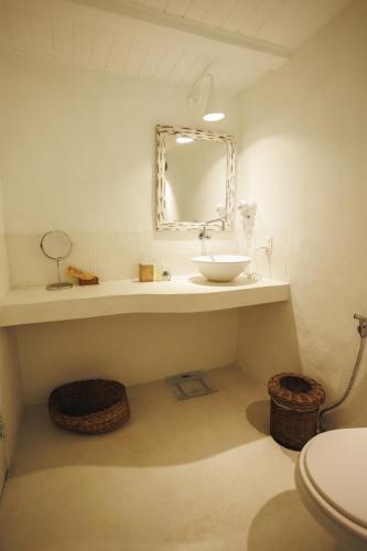 a bathroom with a sink and a mirror at Pousada Capim Santo in Trancoso