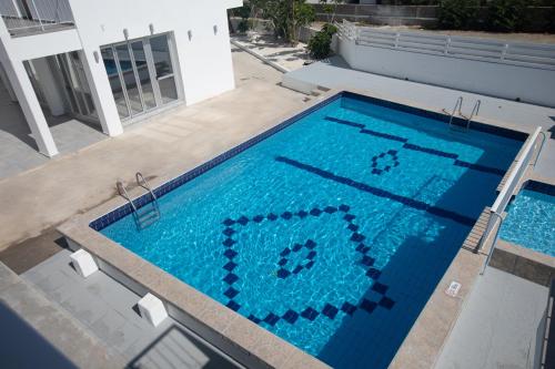 a large swimming pool with a pixelated at Pavlinia Hotel & Apartments in Ayia Napa