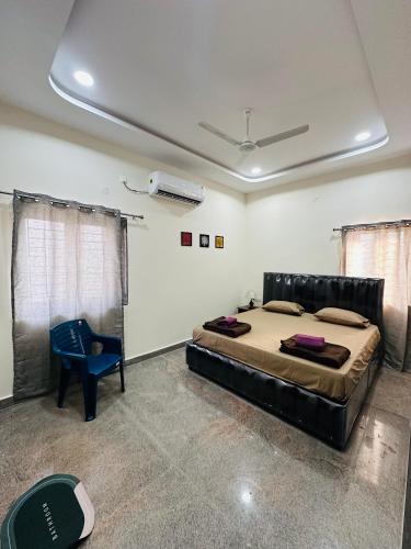 a bedroom with a bed and a blue chair at LOFTEL STAYS in Hyderabad