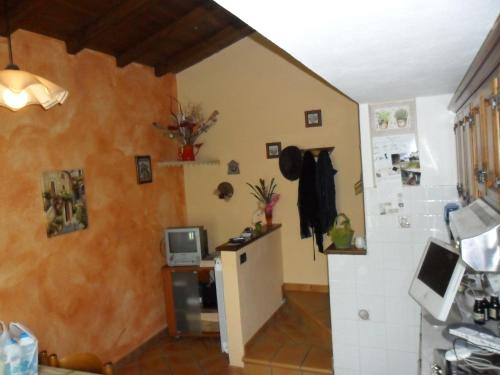 a kitchen with a small refrigerator in a room at Agriturismo La Buca in Cutigliano