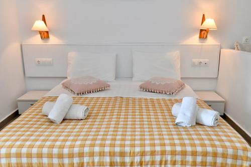 a bedroom with a bed with two pillows on it at Summer View in Theologos