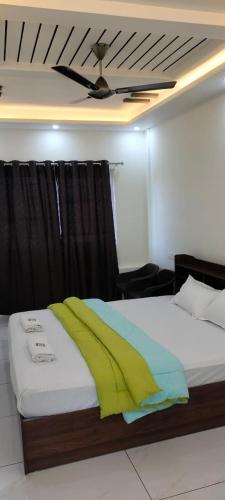 a bedroom with a bed with a ceiling at Panchavati Homestay in Malpe