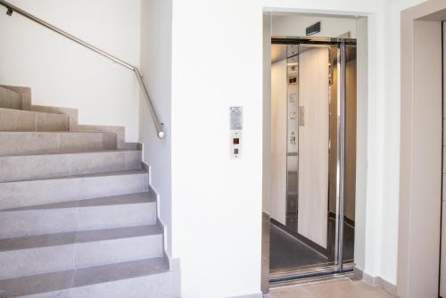 a staircase with a glass door in a building at Anesis Luxury Hospitality in Karpathos Town