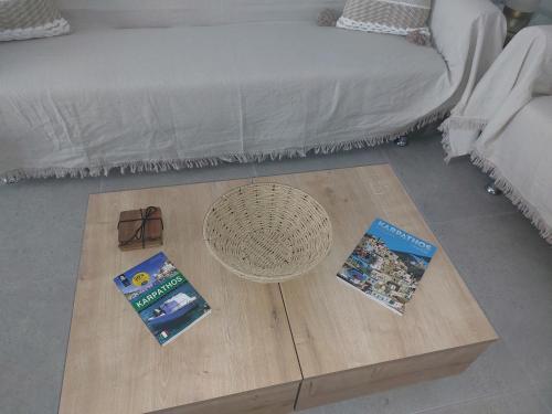 a living room with a coffee table and a bed at Anesis Luxury Hospitality in Karpathos Town