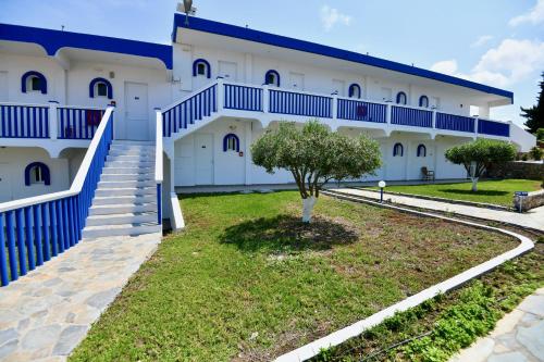 a building with stairs and a tree in front of it at Summer View in Theologos
