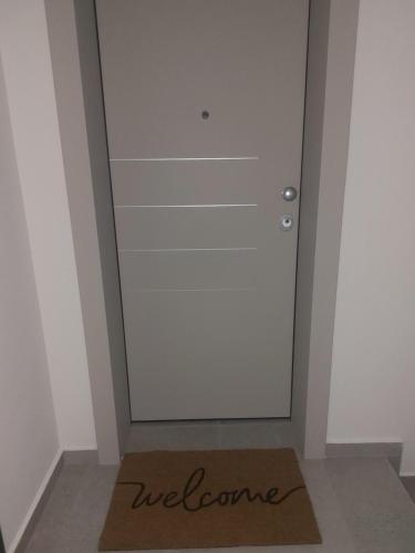 a welcome mat on the floor in front of a door at Anesis Luxury Hospitality in Karpathos Town