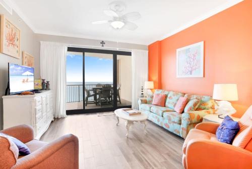 a living room with a couch and a table at Grand Pointe 502- Gulf-front water on 2 sides in Orange Beach