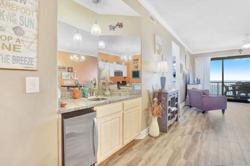 a large kitchen with a sink and a living room at Grand Pointe 502- Gulf-front water on 2 sides in Orange Beach