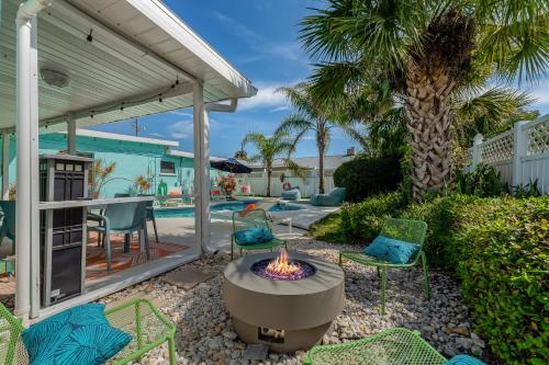 a backyard with a fire pit and patio furniture at Walk to Beach, Heated Pool, Dog-Friendly, Firepit in Daytona Beach