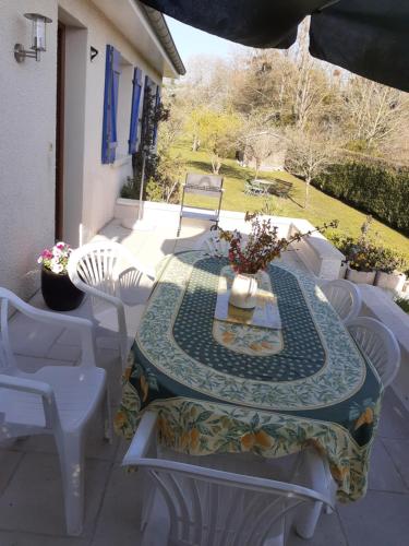 a table and chairs on a patio at Gite de la plage proche de la Saône in Autet