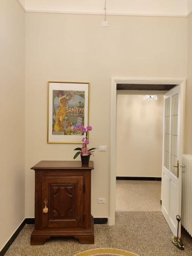 a hallway with a table and a picture on the wall at Residenza d'Epoca Senatore Rolandi Ricci in Albenga