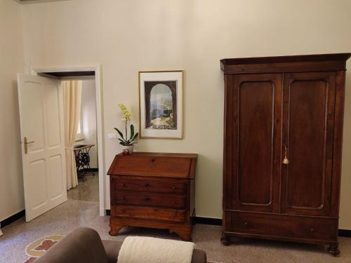a living room with a wooden cabinet and a dresser at Residenza d'Epoca Senatore Rolandi Ricci in Albenga