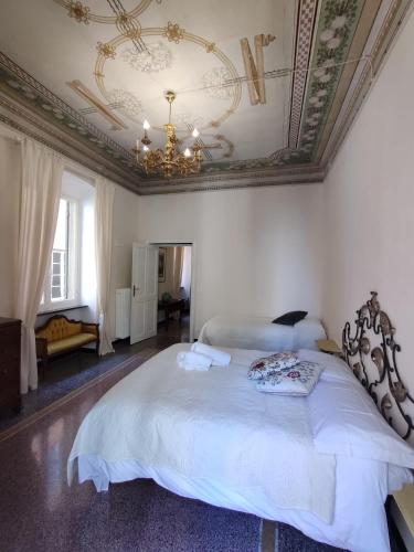 a bedroom with a large bed with a ceiling at Residenza d'Epoca Senatore Rolandi Ricci in Albenga