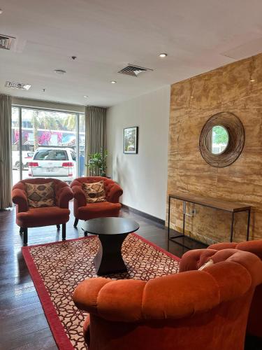 a living room with couches and a table and a fireplace at The residences 1 - Luxury 1BR apt in Downtown Dubai - 2 mins walk to Burj Khalifa & Dubai Mall in Dubai