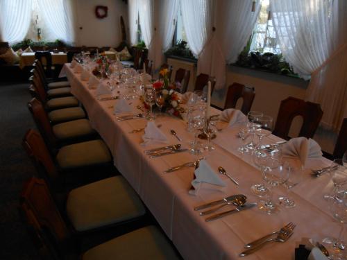 a long table with glasses and napkins on it at Haus Von Der Heyde in Iserlohn
