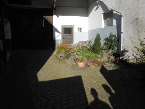 a shadow of a person standing next to a building at Landhaus Düngenheim in Düngenheim